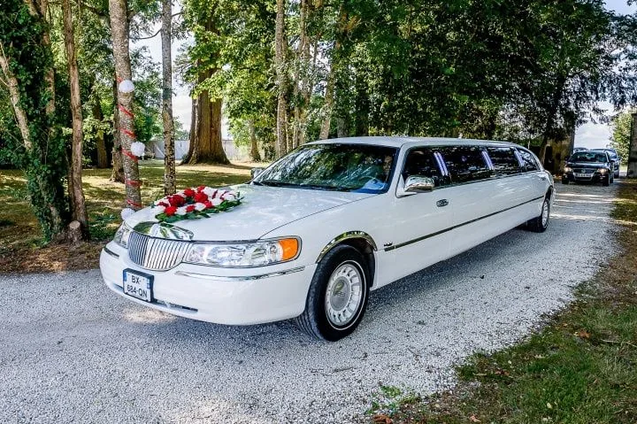 White wedding limousine with floral decoration